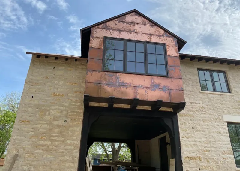 Copper metal panel facade on a stone building for Metal Roof Coating in Sheldon